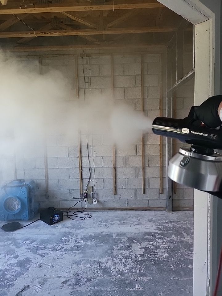 Thermo-fogger dispersing odor counteractant in stripped block wall room